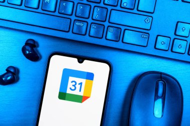 Prague, Czechia - 08 09 2025: A top-down view of a desk with a phone displaying the Google Calendar logo. Google Calendar is a platform for scheduling and managing events.