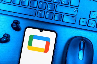 Prague, Czechia - 08 09 2025: A top-down view of a desk with a phone displaying the Google TV logo. Google TV is a platform for streaming movies, shows, and apps.