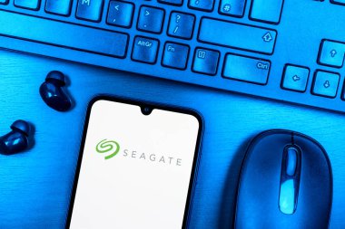 Prague, Czechia - 08 09 2025: A top-down view of a desk with a phone displaying the Seagate logo. Seagate is a company producing hard drives and storage solutions.