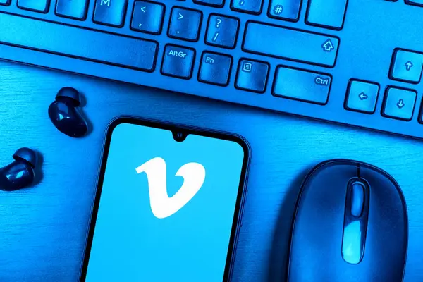 Prague, Czechia - 08 09 2025: A top-down view of a desk with a phone displaying the Vimeo logo. Vimeo is a platform for hosting and sharing high-quality videos.