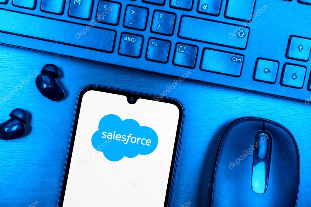 Prague, Czechia - 08 09 2025: A top-down view of a desk with a phone displaying the Salesforce logo. Salesforce is a platform for customer relationship management and cloud services.