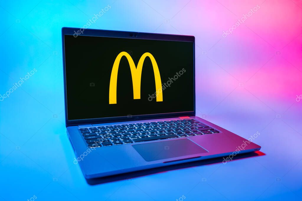 Prague, Czechia - 08 01 2025: A laptop on a uniform background displays the McDonalds logo. McDonalds is a fast-food chain serving burgers, fries, and more.