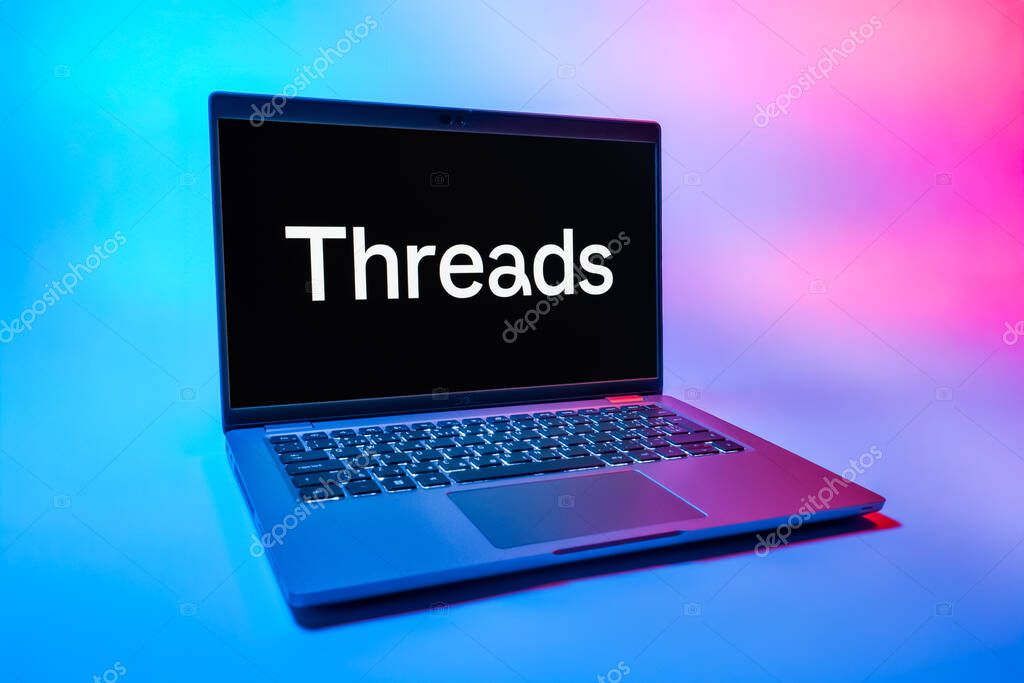 Prague, Czechia - 08 01 2025: A laptop on a uniform background displays the Threads logo. Threads is a social media platform for sharing short posts and updates.