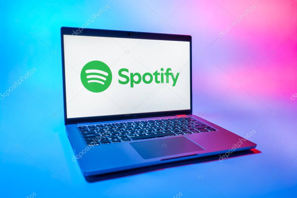 Prague, Czechia - 08 01 2025: A laptop on a uniform background displays the Spotify logo. Spotify is a platform for streaming and discovering music.