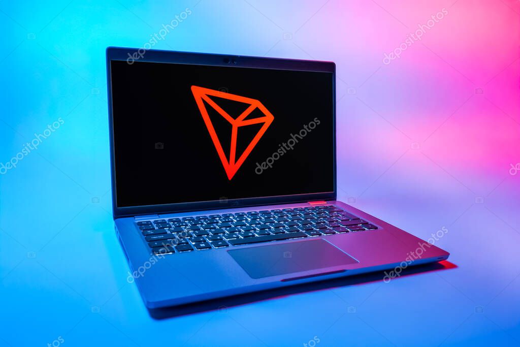 Prague, Czechia - 08 01 2025: A laptop on a uniform background displays the Tron logo. Tron is a blockchain platform for decentralized applications.