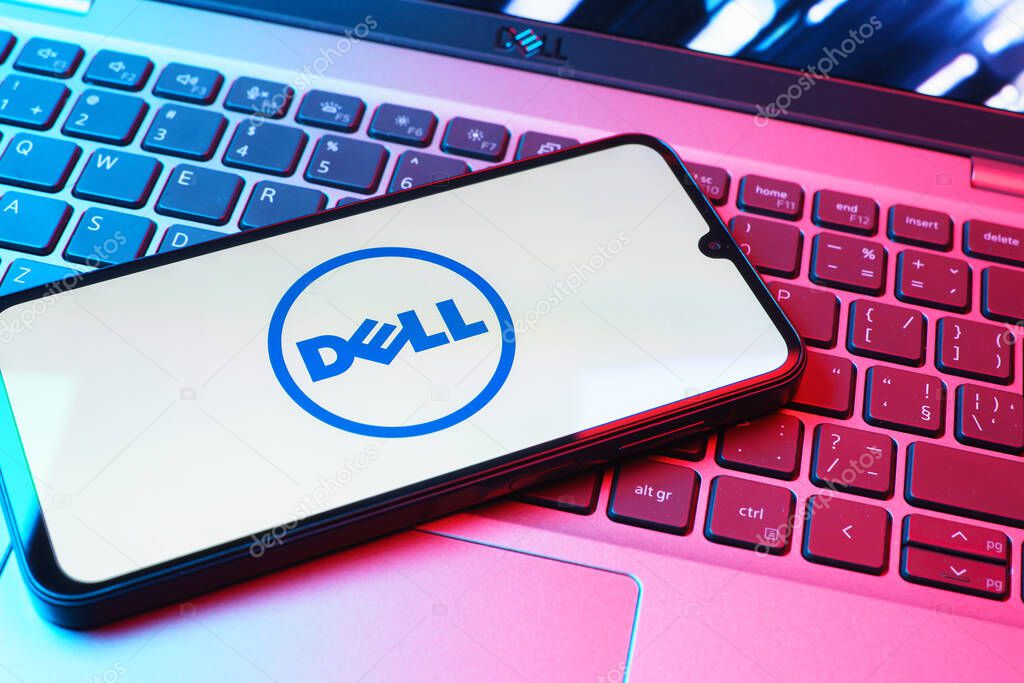 Prague, Czechia - 08 01 2025: A mobile phone lying on a laptop keyboard displays the Dell logo. Dell is a technology company producing computers and IT solutions.