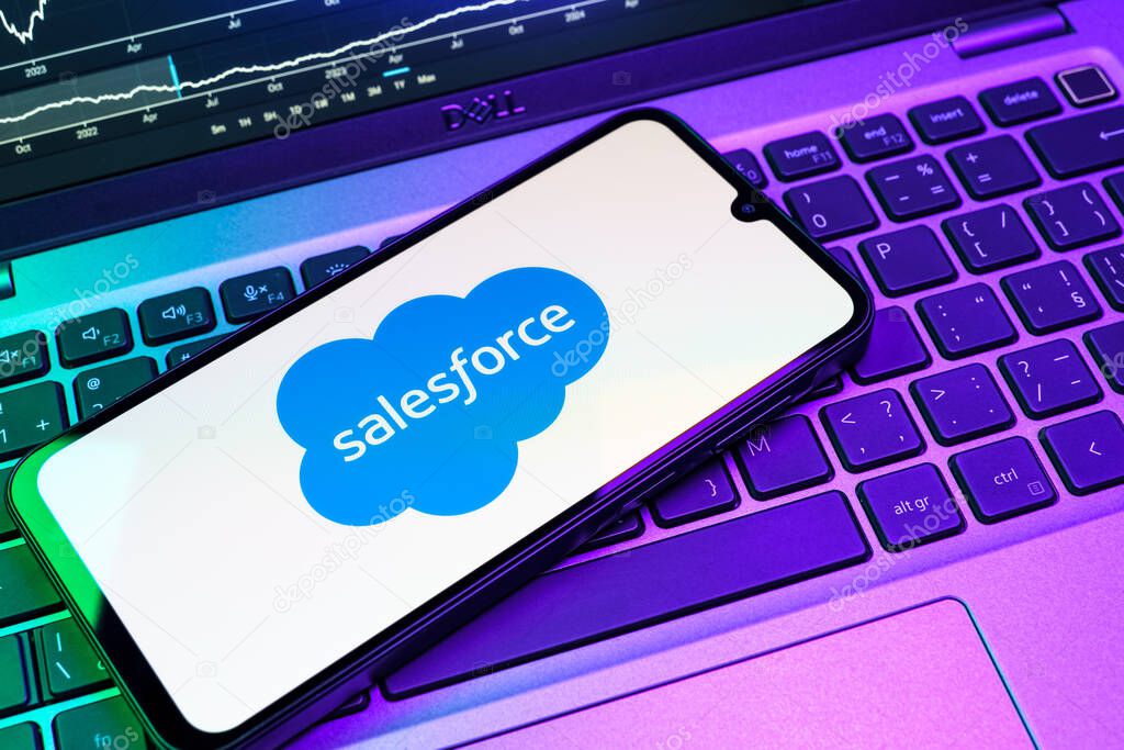 Prague, Czechia - 08 18 2025: A mobile phone on a keyboard displays Salesforce logo. Salesforce is a platform for customer relationship management and cloud services.