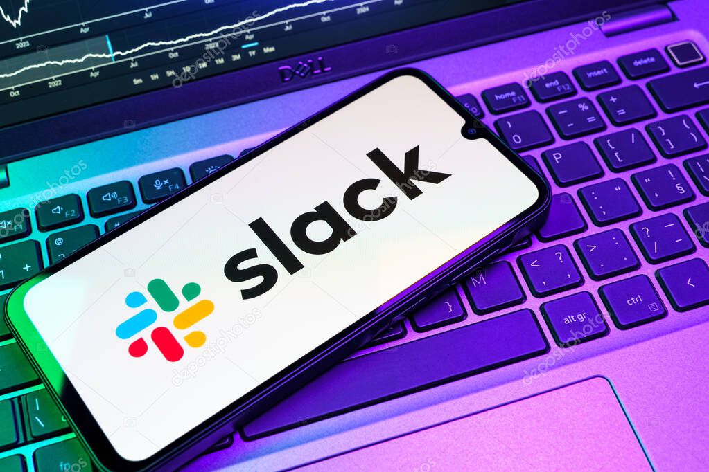Prague, Czechia - 08 18 2025: A mobile phone on a keyboard displays Slack logo. Slack is a platform for team messaging and workplace communication.