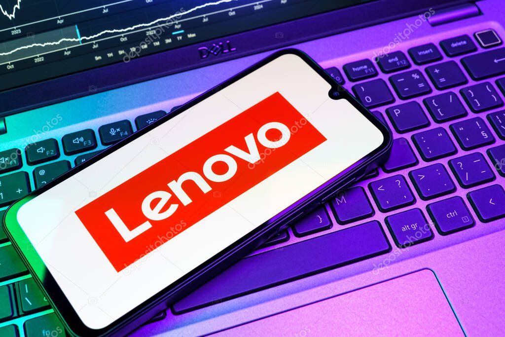 Prague, Czechia - 08 18 2025: A mobile phone on a keyboard displays Lenovo logo. Lenovo is a technology company producing computers and electronics.