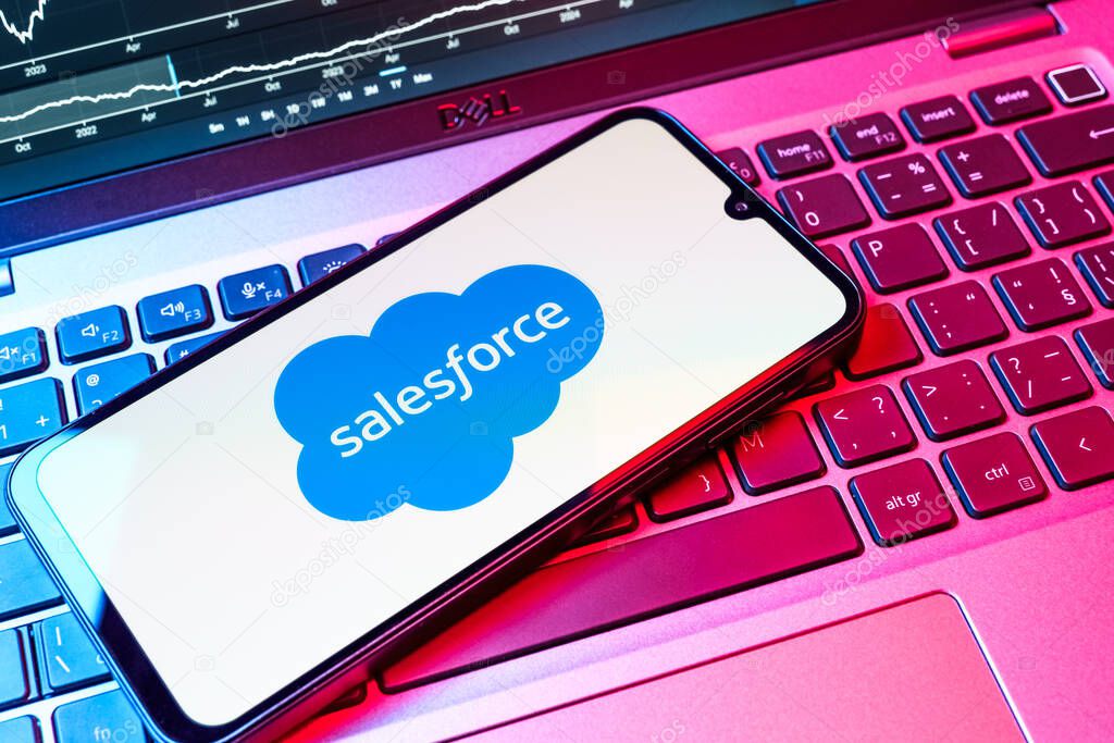 Prague, Czechia - 08 18 2025: A mobile phone on a keyboard displays Salesforce logo. Salesforce is a platform for customer relationship management and cloud services.