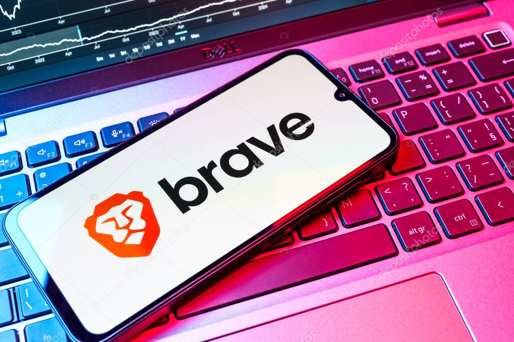 Prague, Czechia - 08 18 2025: A mobile phone on a keyboard displays Brave logo. Brave is a web browser focused on privacy and speed.