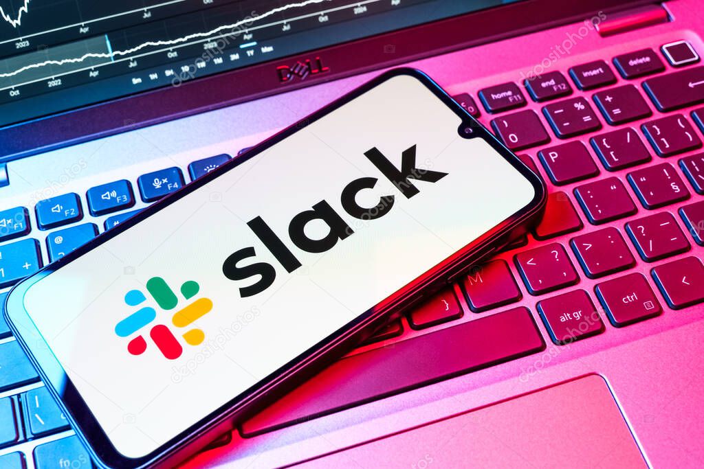 Prague, Czechia - 08 18 2025: A mobile phone on a keyboard displays Slack logo. Slack is a platform for team messaging and workplace communication.