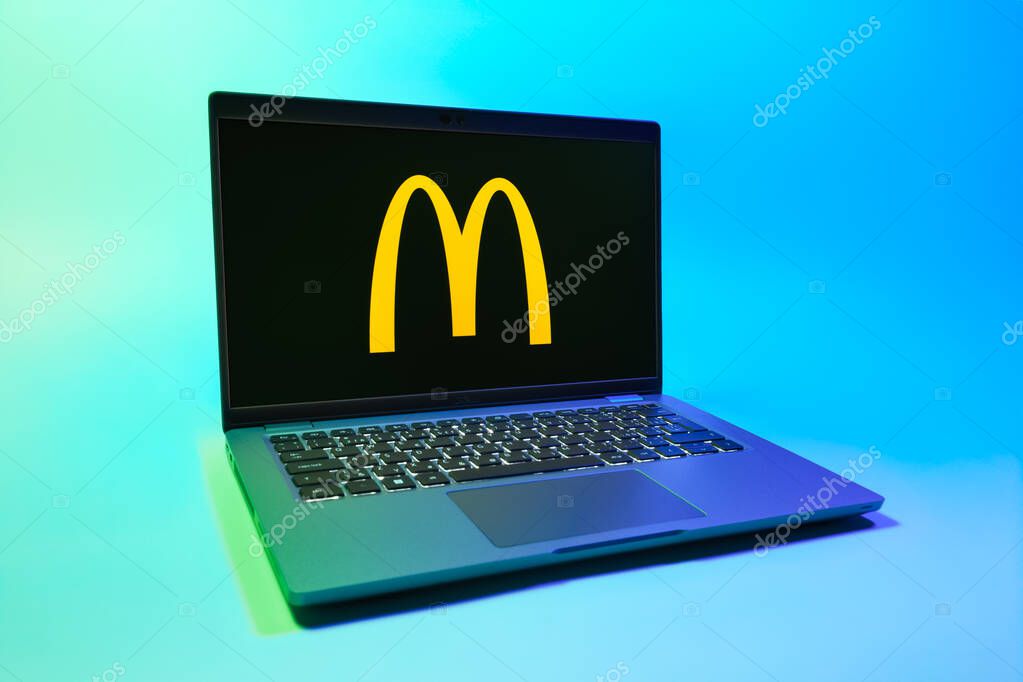 Prague, Czechia - 08 01 2025: A laptop on a uniform background displays the McDonalds logo. McDonalds is a fast-food chain serving burgers, fries, and more.