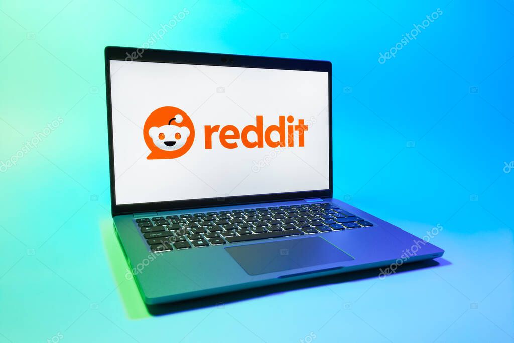 Prague, Czechia - 08 01 2025: A laptop on a uniform background displays the Reddit logo. Reddit is a platform for discussion, news, and community content.