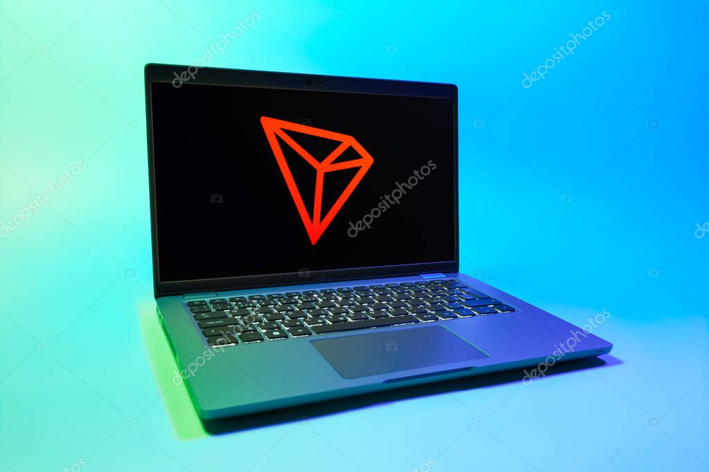 Prague, Czechia - 08 01 2025: A laptop on a uniform background displays the Tron logo. Tron is a blockchain platform for decentralized applications.