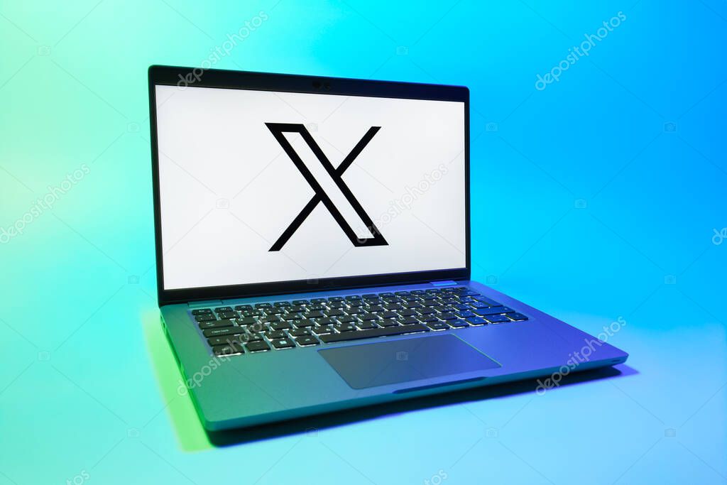 Prague, Czechia - 08 01 2025: A laptop on a uniform background displays the X logo. X is a platform for sharing short posts and updates.