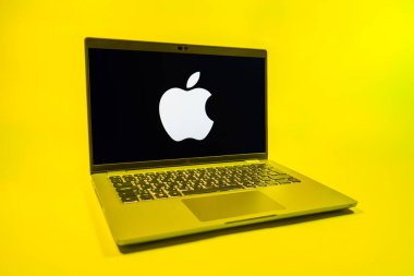 Prag, Çek Cumhuriyeti - 08 01 2025: Uniforma arka planda bir dizüstü bilgisayar Apple logosunu gösterir. Apple iPhone, bilgisayar ve hizmet üreten bir teknoloji şirketidir..