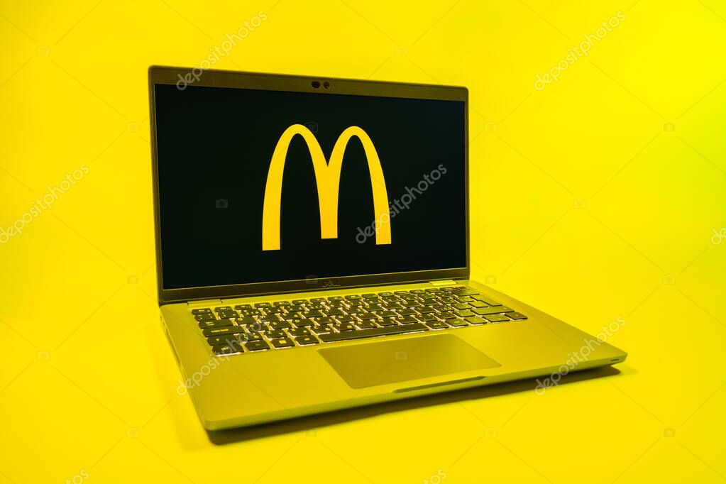 Prague, Czechia - 08 01 2025: A laptop on a uniform background displays the McDonalds logo. McDonalds is a fast-food chain serving burgers, fries, and more.