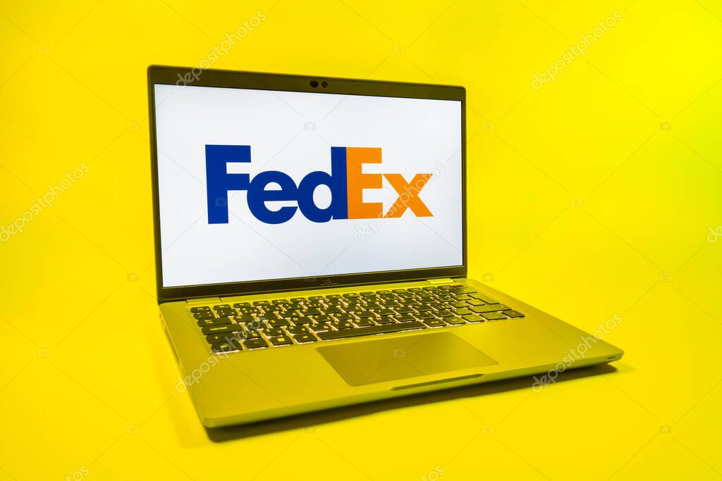 Prague, Czechia - 08 01 2025: A laptop on a uniform background displays the FedEX logo. FedEX is a logistics company providing shipping and courier services.