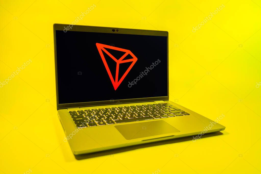 Prague, Czechia - 08 01 2025: A laptop on a uniform background displays the Tron logo. Tron is a blockchain platform for decentralized applications.
