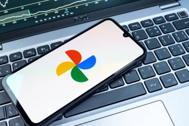Prag, Çek Cumhuriyeti - 08 18 2025: Bir klavyede bir cep telefonu Google Photos logosunu görüntüler. Google Fotoğrafları fotoğraf ve videoları saklamak ve düzenlemek için bir platformdur.