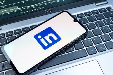 Prag, Çek Cumhuriyeti - 08 18 2025: Klavyede bir cep telefonu LinkedIn logosunu gösterir. LinkedIn, insanları ve şirketleri birbirine bağlayan profesyonel bir ağ..