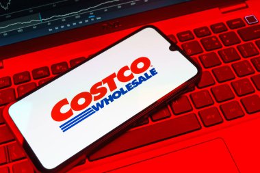 Prag, Çek Cumhuriyeti - 08 18 2025: Klavyede bir cep telefonu Costco logosu sergiler. Costco toptan satış yapan bir perakendecidir. Üyelere toptan ürün satar..