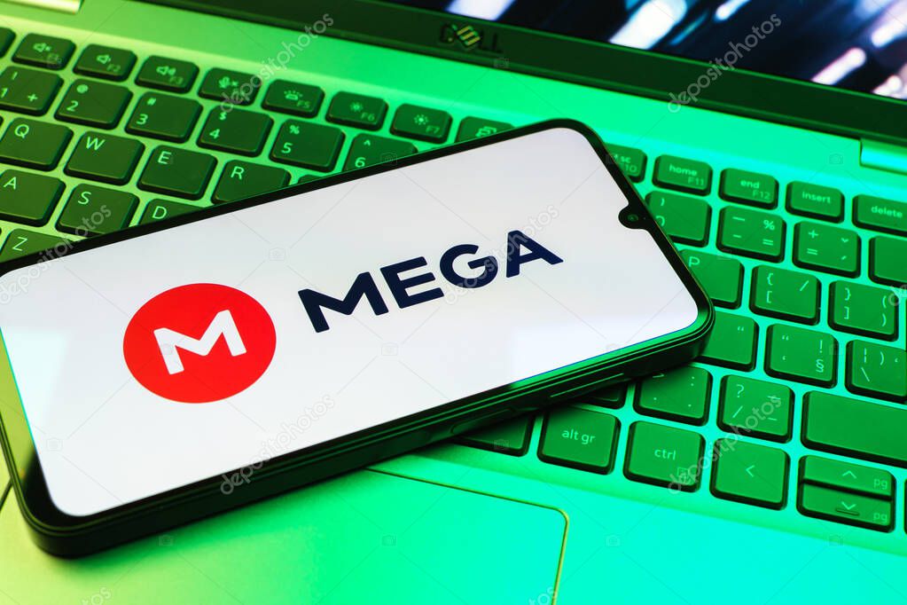 Prague, Czechia - 08 01 2025: A mobile phone lying on a laptop keyboard displays the Mega logo. Mega is a platform for cloud storage with encrypted file sharing.