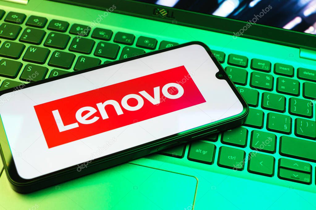 Prague, Czechia - 08 01 2025: A mobile phone lying on a laptop keyboard displays the Lenovo logo. Lenovo is a technology company producing computers and electronics.