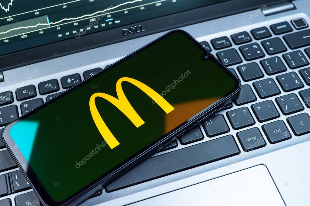 Prague, Czechia - 08 18 2025: A mobile phone on a keyboard displays McDonalds logo. McDonalds is a fast-food chain serving burgers, fries, and more.