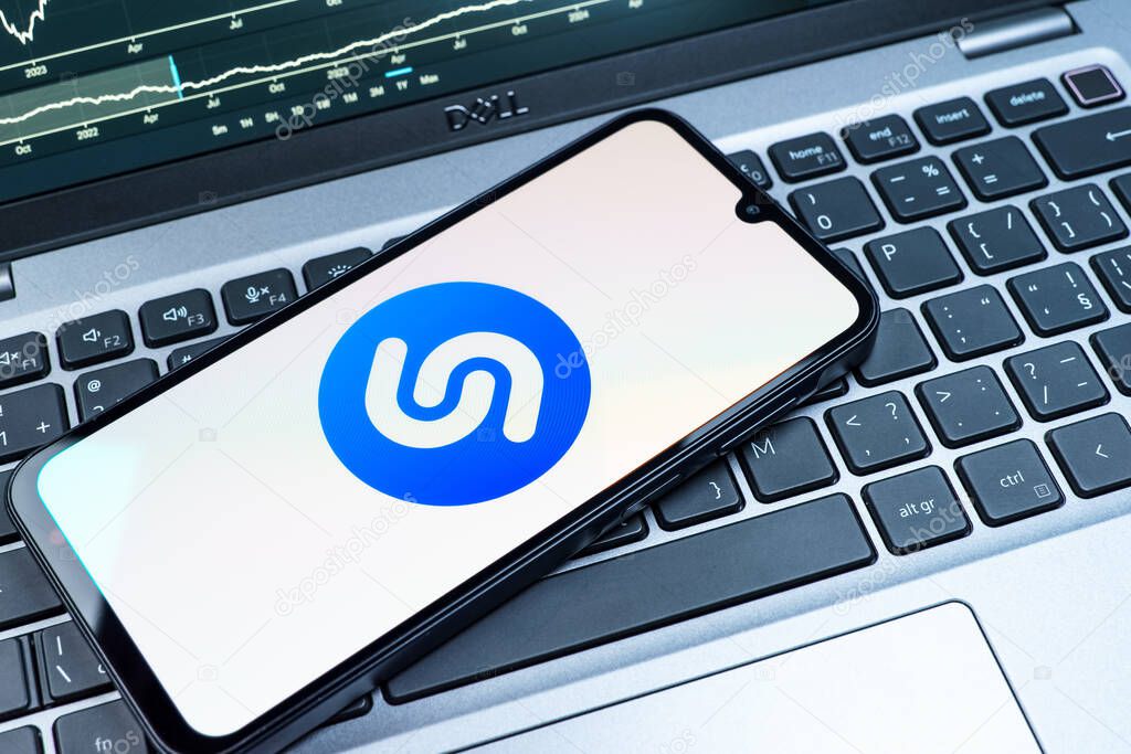 Prague, Czechia - 08 18 2025: A mobile phone on a keyboard displays Shazam logo. Shazam is an app for identifying songs and music tracks.