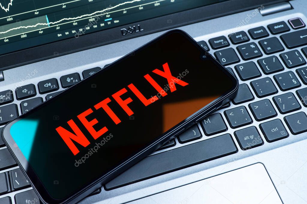 Prague, Czechia - 08 18 2025: A mobile phone on a keyboard displays Netflix logo. Netflix is a streaming platform for movies and TV shows.