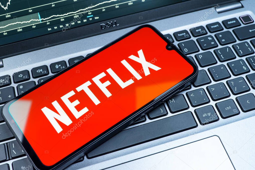 Prague, Czechia - 08 18 2025: A mobile phone on a keyboard displays Netflix logo. Netflix is a streaming platform for movies and TV shows.