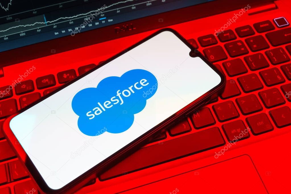 Prague, Czechia - 08 18 2025: A mobile phone on a keyboard displays Salesforce logo. Salesforce is a platform for customer relationship management and cloud services.