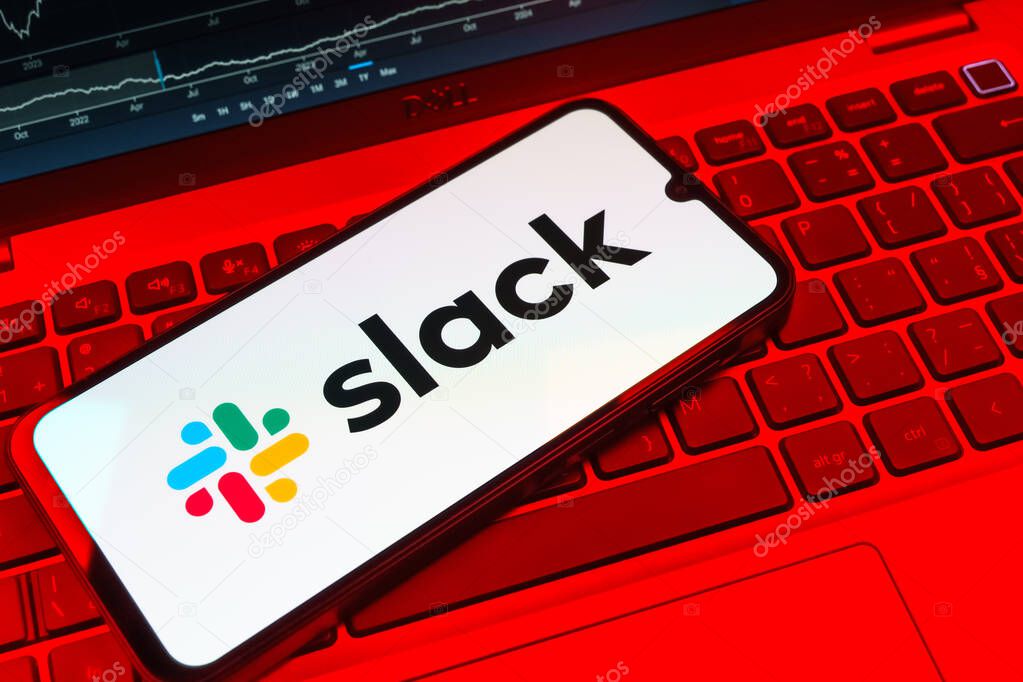 Prague, Czechia - 08 18 2025: A mobile phone on a keyboard displays Slack logo. Slack is a platform for team messaging and workplace communication.