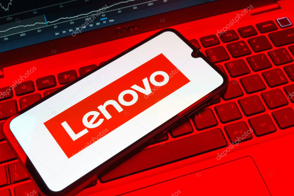 Prague, Czechia - 08 18 2025: A mobile phone on a keyboard displays Lenovo logo. Lenovo is a technology company producing computers and electronics.
