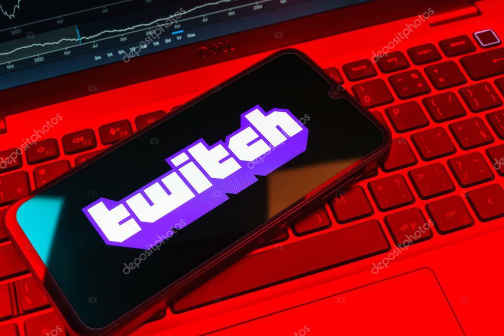 Prague, Czechia - 08 18 2025: A mobile phone on a keyboard displays Twitch logo. Twitch is a platform for live streaming games and content.