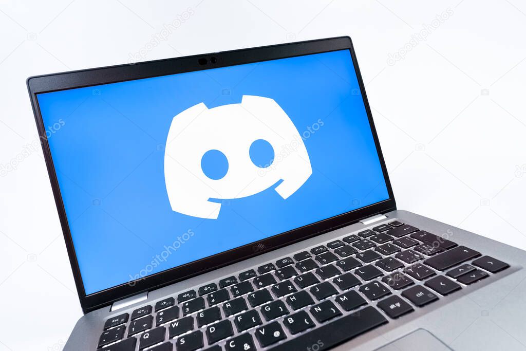 Prague, Czechia - 08 12 2025: A dynamic close-up of a laptop displaying the Discord logo. Discord is a platform for voice, video, and text communication.