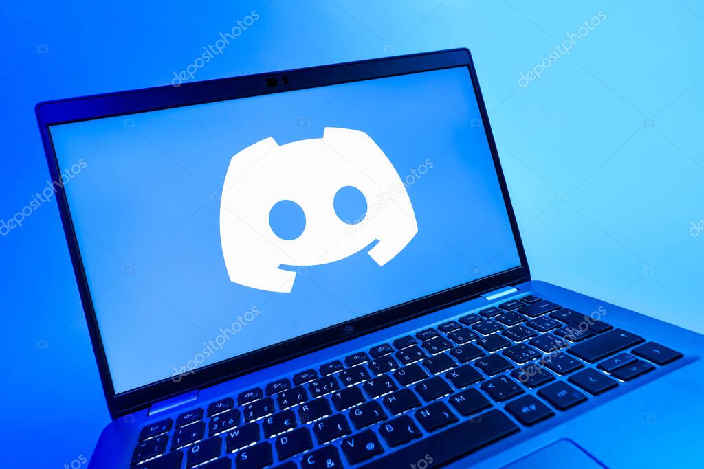 Prague, Czechia - 08 12 2025: A dynamic close-up of a laptop displaying the Discord logo. Discord is a platform for voice, video, and text communication.