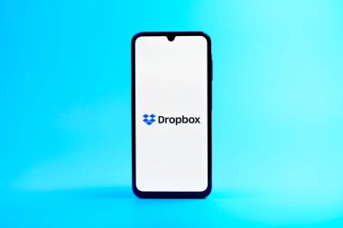 Prag, Çek Cumhuriyeti - 08 10 2025: Arka planda duran bir cep telefonu Dropbox logosunu gösteriyor. Dropbox bulut depolama ve dosya paylaşımı için bir platformdur.