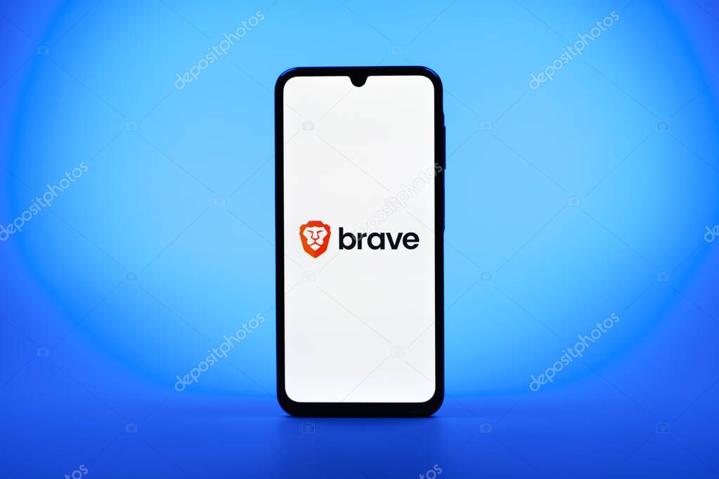 Prague, Czechia - 08 10 2025: A mobile phone standing on a uniform background displays the Brave logo. Brave is a web browser focused on privacy and speed.