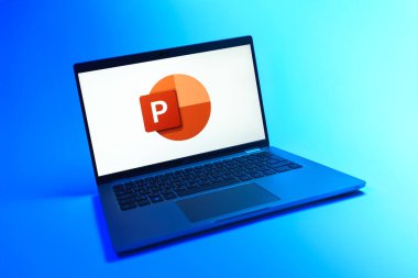 Prag, Çek Cumhuriyeti - 08 12 2025: Powerpoint logosunu gösteren tek bir arkaplanda dinamik bir dizüstü bilgisayar görüntüsü. Powerpoint sunumlar ve slayt gösterileri oluşturmak için bir yazılımdır..