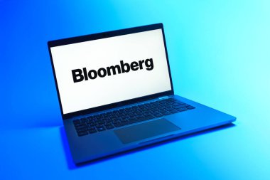 Prague, Czechia - 08 12 2025: A dynamic view of a laptop on a uniform background displaying the Bloomberg logo. Bloomberg is a company providing financial news, data, and analytics.
