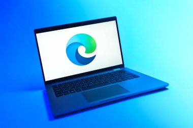 Prague, Czechia - 08 12 2025: A dynamic view of a laptop on a uniform background displaying the Edge logo. Edge is a web browser developed by Microsoft for Windows devices.