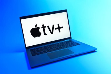 Prague, Czechia - 08 12 2025: A dynamic view of a laptop on a uniform background displaying the Apple TV+ logo. Apple TV+ is a streaming platform for movies and TV shows.