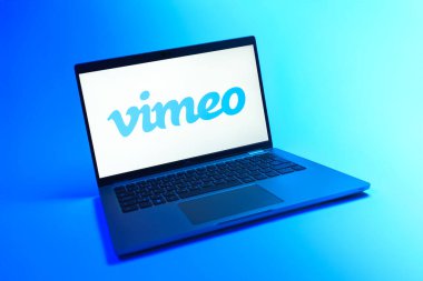 Prague, Czechia - 08 12 2025: A dynamic view of a laptop on a uniform background displaying the Vimeo logo. Vimeo is a platform for hosting and sharing high-quality videos.