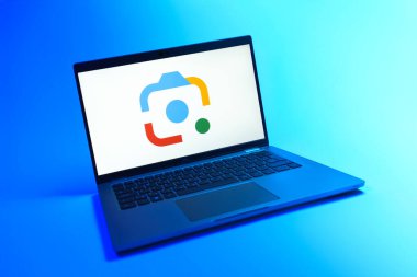 Prague, Czechia - 08 12 2025: A dynamic view of a laptop on a uniform background displaying the Google Lens logo. Google Lens is a tool for visual search and information from images.