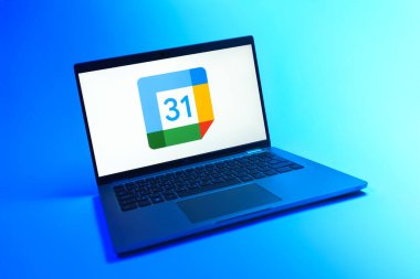 Prague, Czechia - 08 12 2025: A dynamic view of a laptop on a uniform background displaying the Google Calendar logo. Google Calendar is a platform for scheduling and managing events.