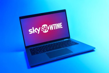 Prague, Czechia - 08 12 2025: A dynamic view of a laptop on a uniform background displaying the SkyShowtime logo. SkyShowtime is a streaming platform for movies and TV series.