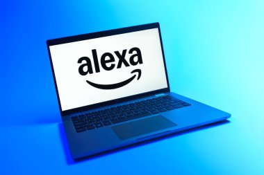 Prague, Czechia - 08 12 2025: A dynamic view of a laptop on a uniform background displaying the Alexa logo. Alexa is a voice assistant for smart devices and services.
